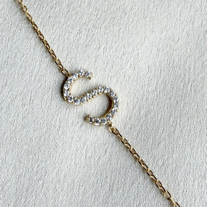 Gold necklace with a letter S made from cubic zirconia crystals