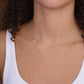 Gold necklace with a cubic zirconia initial worn by a female
