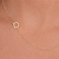 Gold necklace with cz pavé initial set sideways on a delicate chain